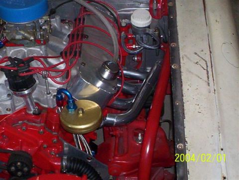 1963 Ford Falcon - Close-up view of a modified V8 engine, a carburetor, distributor, and custom exhaust headers.
