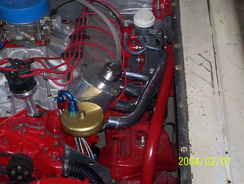 Engine bay with V8 engine, carburetor, distributor, and exhaust headers