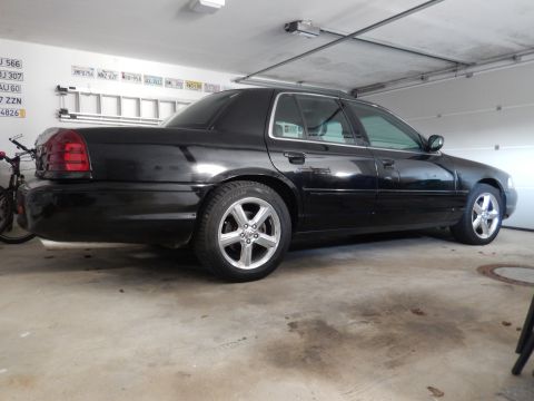 2003 Mercury Marauder - A black 2003 Mercury Marauder sedan is parked in a garage, viewed from the rear quarter angle.