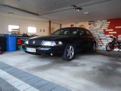 2003 Mercury Marauder - A black 2003 Mercury Marauder is parked in a garage with a world map mural on the wall.