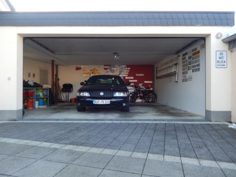 2003 Mercury Marauder - A black 2003 Mercury Marauder is parked inside a garage, with a motorcycle visible behind it.
