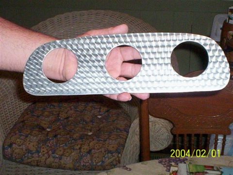 1963 Ford Falcon - A custom aluminum gauge cluster bezel with a diamond plate pattern is held up for inspection.