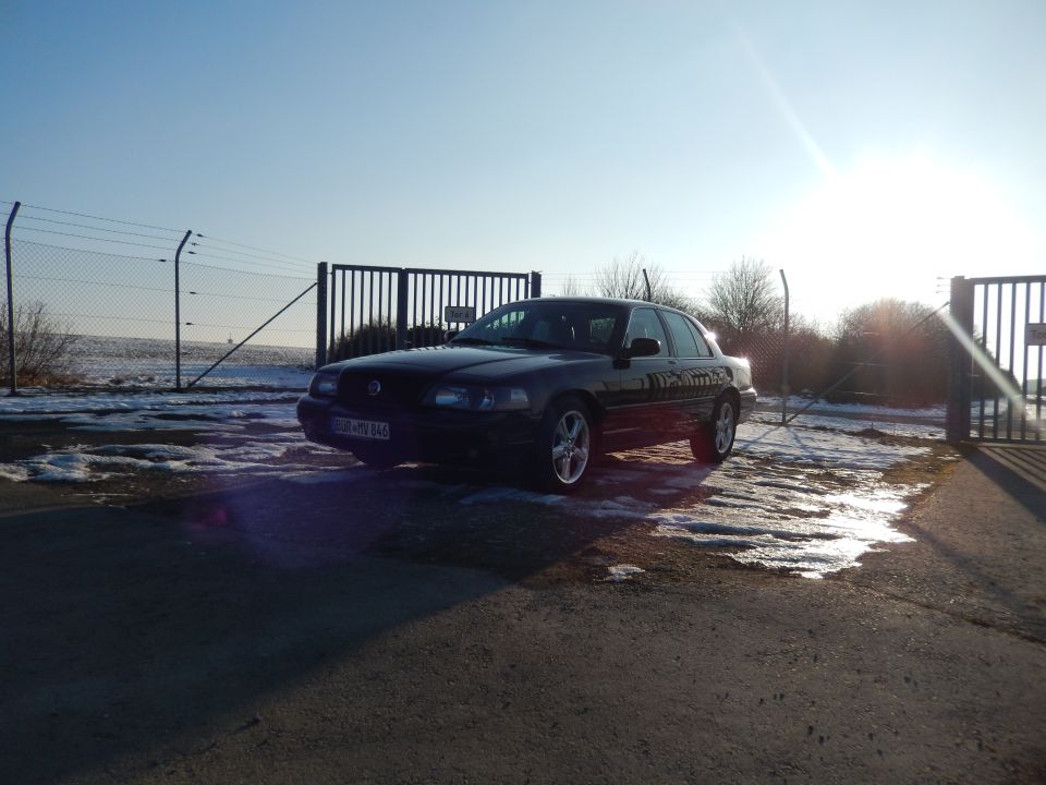 Black 2003 Mercury Marauder parked on a sunny day with snow patches