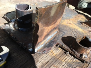 1995 Ford Bronco - A close-up view of a fabricated metal bracket, showing signs of wear and welding.