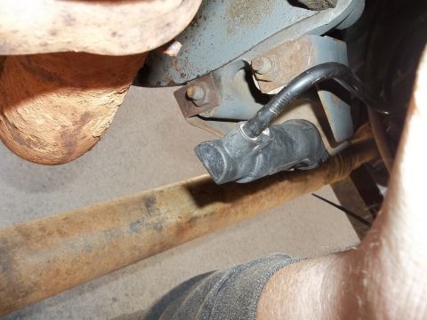 1995 Ford Bronco - A close-up view of a vehicle's undercarriage, focusing on an exhaust component and wiring.