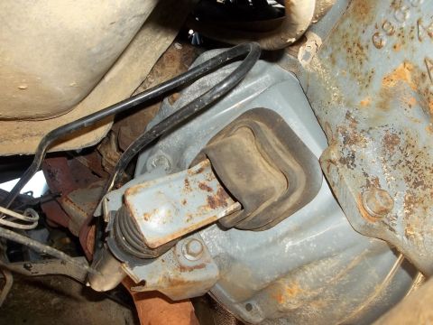 1995 Ford Bronco - Close-up view of a vehicle's transmission mount, showing the rubber isolator and attached wiring.