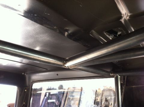 1995 Ford Bronco - View of a custom roll cage installed inside a vehicle's interior.