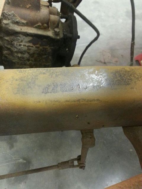 1909 Ford Model T - A close-up view of a rusty metal beam with stamped identification numbers.