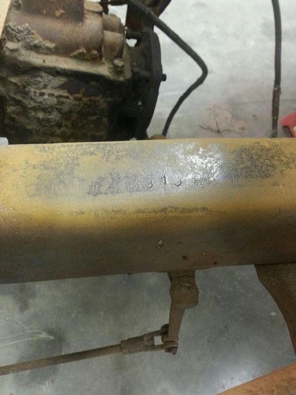 Rusty metal beam with stamped numbers 'XY031584'
