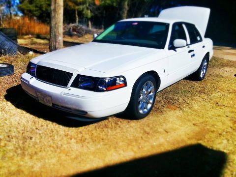 2000 Mercury Grand Marquis - This 2000 Mercury Grand Marquis is shown in a three-quarter front view with its hood open.