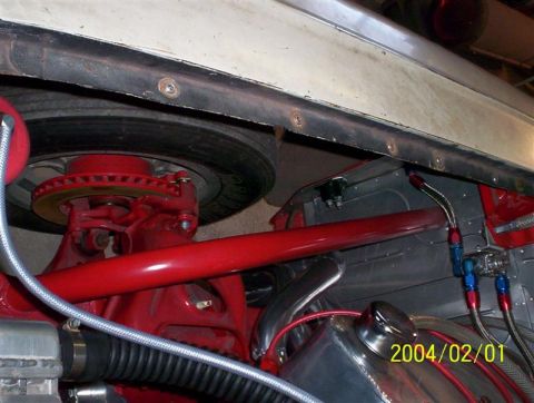 1963 Ford Falcon - Close-up of the undercarriage, showing red suspension components and a brake rotor, with a date stamp of 2004/02/01.