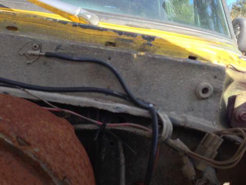 1979 Ford Bronco - Detail shot of the engine bay, focusing on the wiring harness and firewall area of the vehicle.