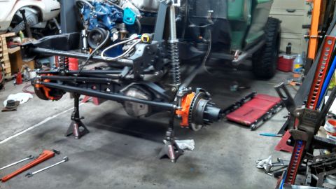 1967 Ford F-250 - The chassis of a 1967 Ford F-250 is supported by jack stands during a repair or restoration process.