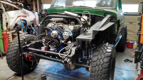 1967 Ford F-250 - Modified truck chassis undergoing work, showing engine and suspension components.