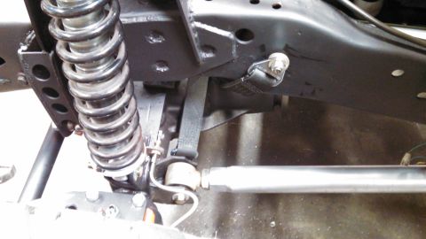 1967 Ford F-250 - Detail of a truck's suspension system, including a coil spring and shock absorber.