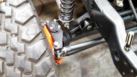 1967 Ford F-250 - Custom suspension components are visible on this vehicle's chassis, with a large off-road tire in the foreground.