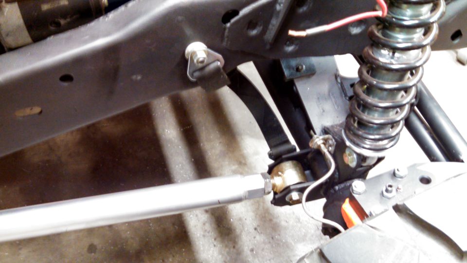 Close-up of vehicle suspension with shock absorber and linkage