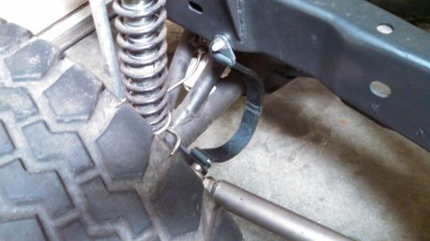 1967 Ford F-250 - Detail of a truck's suspension system, including a coil spring and part of the frame.