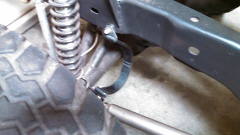 1967 Ford F-250 - Detail shot of a vehicle's frame and suspension components, including a coil spring and part of a tire.