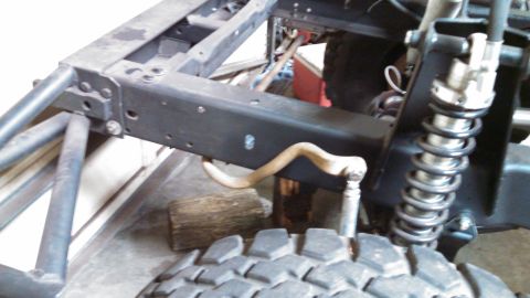 1967 Ford F-250 - The underside of a vehicle, focusing on the frame and suspension components, with a tire visible.