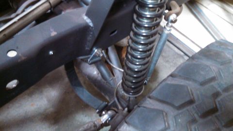 1967 Ford F-250 - A detailed view of a truck's suspension system, including the frame, shock, and tire, is shown.