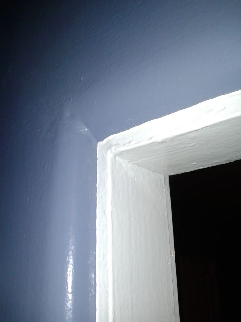1990 Ford Bronco - A view of a doorway with a blue wall and white trim.