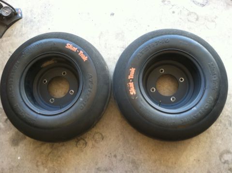 2005 Honda TRX 450 R - Two black Skat-Trak tires are shown, each with orange branding and a black rim.