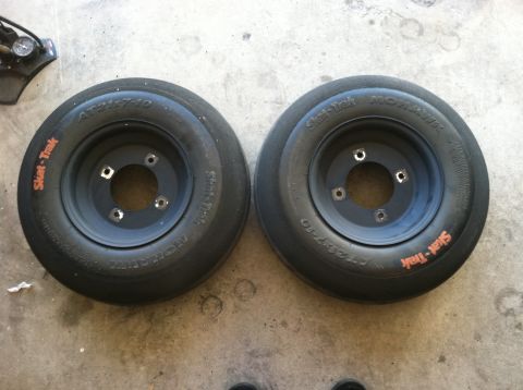 2005 Honda TRX 450 R - Pair of Skat-Trak ATV tires with black rims, size AT21x7-10, on a concrete surface.
