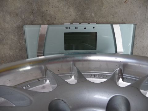 1993 Mazda MX-3 - A car wheel is placed on a digital scale, showing the word 'JAPAN' on the wheel.