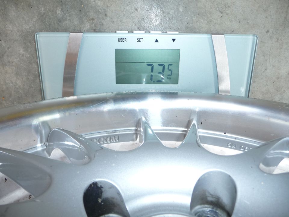 Wheel on a digital scale showing 7.75 kg