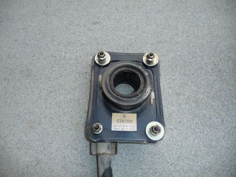 1993 Mazda MX-3 - A close-up view of a vehicle suspension component with a label indicating part number EA03A.