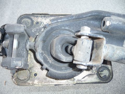 1993 Mazda MX-3 - Close-up of a vehicle's suspension component, showing rubber and metal parts.
