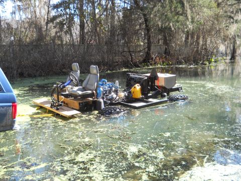 1992 Ford Bronco - Custom amphibious vehicle with two seats and engine in swampy water.