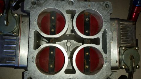 1995 Ford Bronco - Close-up of a four-barrel carburetor, a critical engine component for fuel delivery.