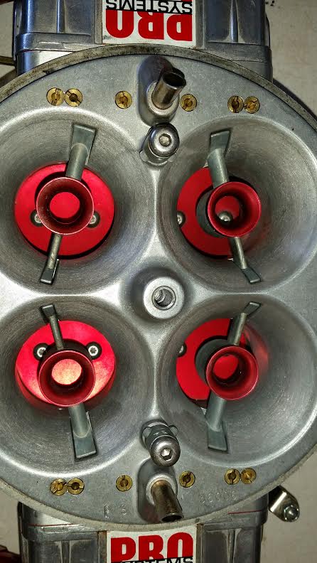 1995 Ford Bronco - Close-up of a Pro Systems carburetor, four intake ports with red velocity stacks.