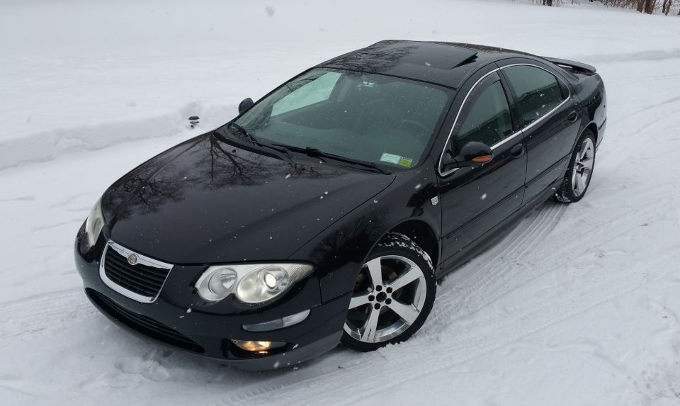 Black 2002 Chrysler 300M parked in snow, front 3/4 view