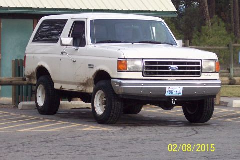 1990 Ford Bronco - This 1990 Ford Bronco is shown from the front-right, with mud on its lower body and tires.