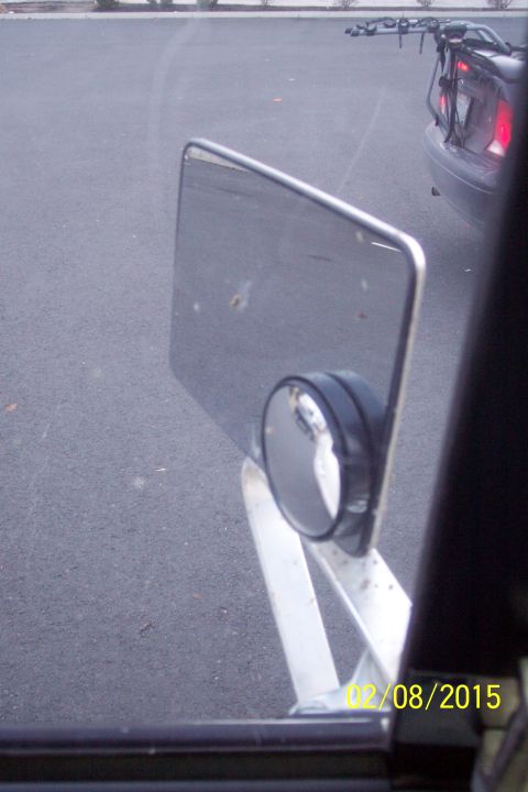 1990 Ford Bronco - A side mirror and the rear of a car with a bike rack are visible in this image, dated 02/08/2015.