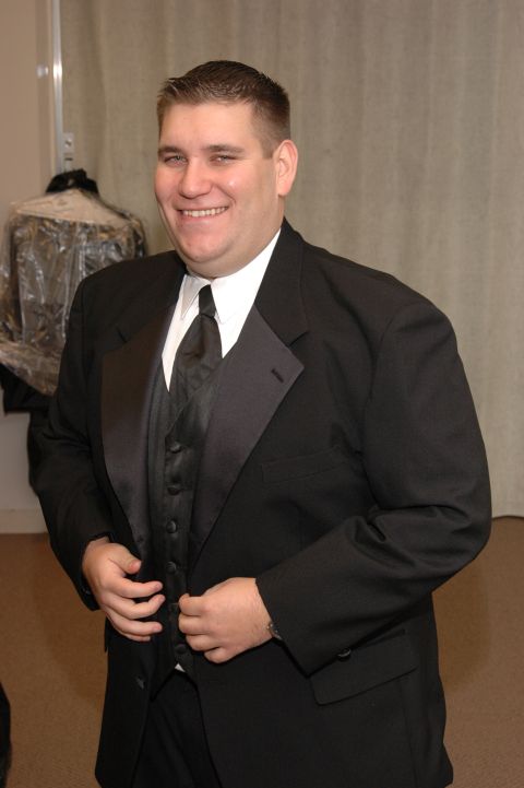 1985 Ford Crown Victoria LTD - A man smiles while adjusting his tuxedo before a wedding event.