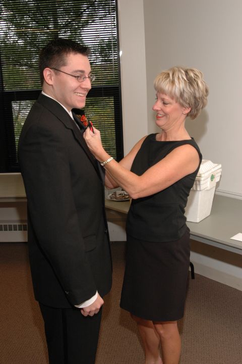1985 Ford Crown Victoria LTD - A woman helps a man adjust his tie before an event.