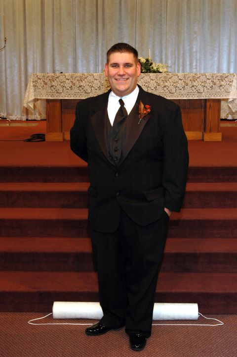 1985 Ford Crown Victoria LTD - A groom poses for a photo in his tuxedo before a wedding ceremony.
