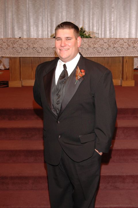 1985 Ford Crown Victoria LTD - Groom poses for a photo in his wedding attire.