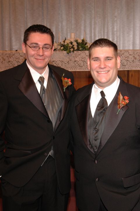 1985 Ford Crown Victoria LTD - Two men in formal wear pose for a photograph, likely at a wedding ceremony.