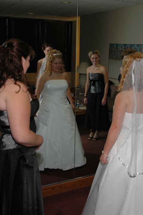 1985 Ford Crown Victoria LTD - A bride and her bridesmaids prepare for a wedding, reflected in a large mirror.