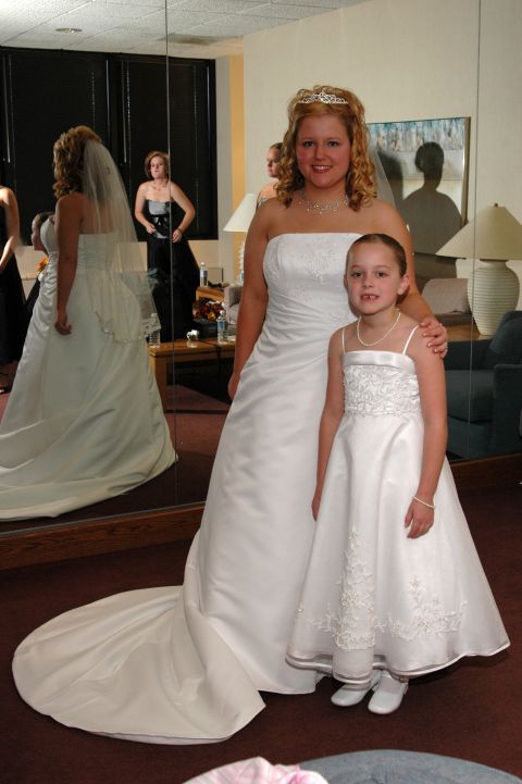 1985 Ford Crown Victoria LTD - Bride and flower girl pose for a photo in wedding attire, with reflections in a large mirror.