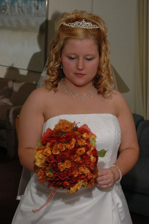 1985 Ford Crown Victoria LTD - A bride poses for a photo while holding a bouquet of flowers.