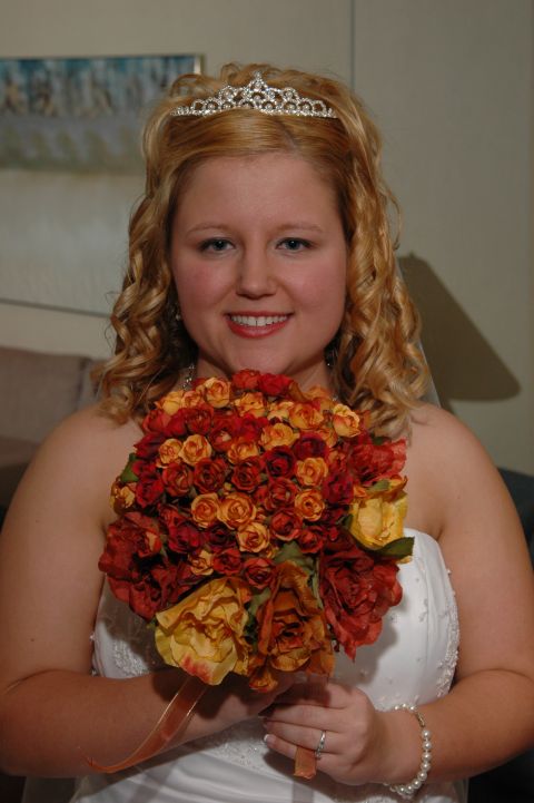 1985 Ford Crown Victoria LTD - A bride smiles while holding a colorful bouquet of flowers, ready for her wedding ceremony.