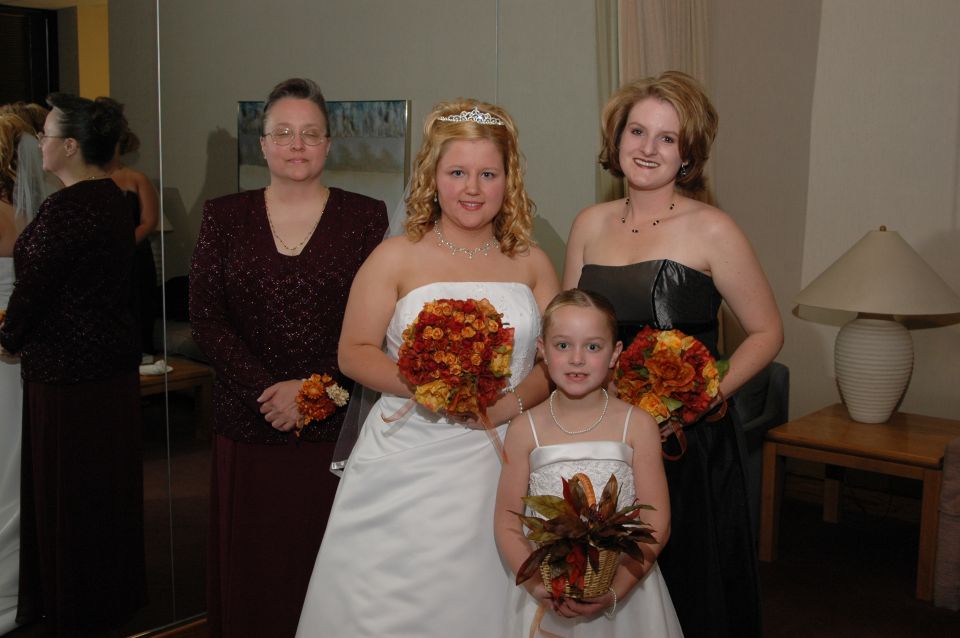 Bride and bridesmaids posing for a photo indoors
