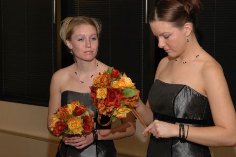 1985 Ford Crown Victoria LTD - Bridesmaids holding floral bouquets at a wedding event.