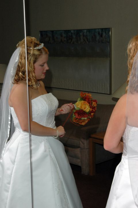 1985 Ford Crown Victoria LTD - A bride prepares for her wedding, holding a colorful bouquet.